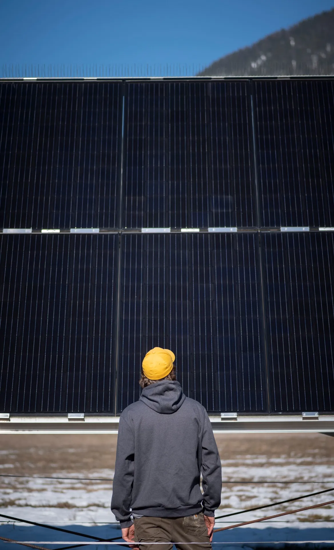 Professional inspecting large-scale solar panel installation — Mitchell & Sun Electrical, Creston BC