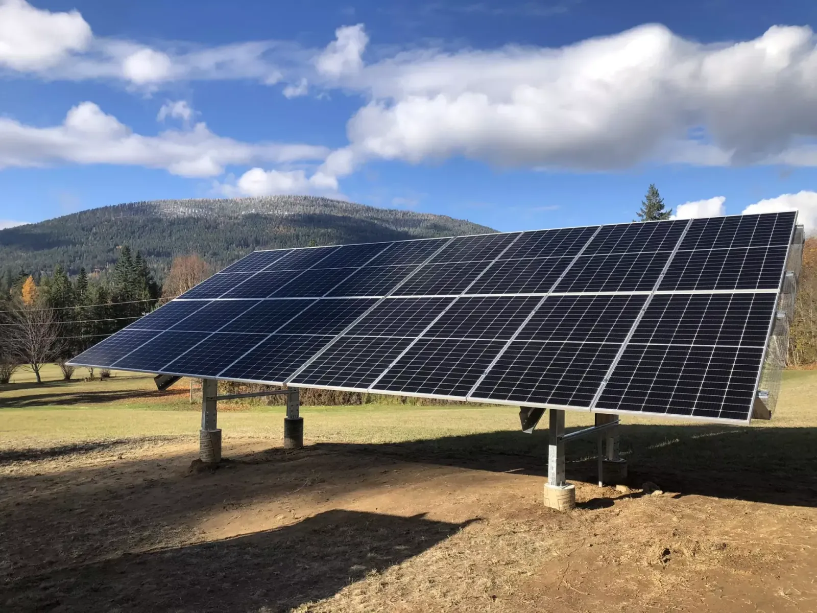 Ground-mounted solar array with mountain backdrop